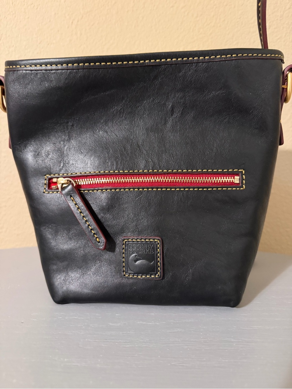 Dooney & Bourke Black Leather Crossbody with Red Zip and Gold Hardware